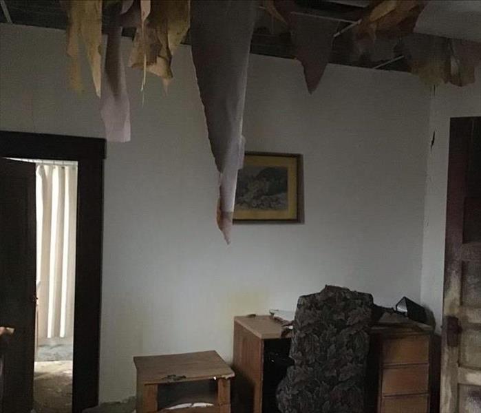 Photo of dorm room with water damage that caused ceiling to fall 