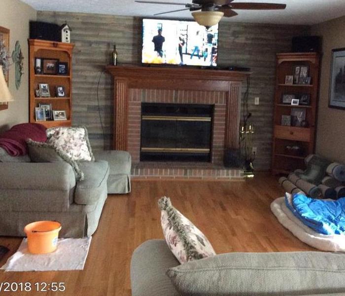 Photo of same living room cleaned and remodeled